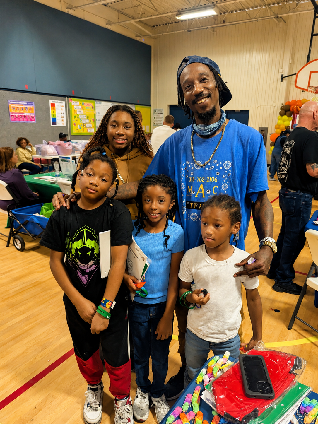 A father and his four children at a community event